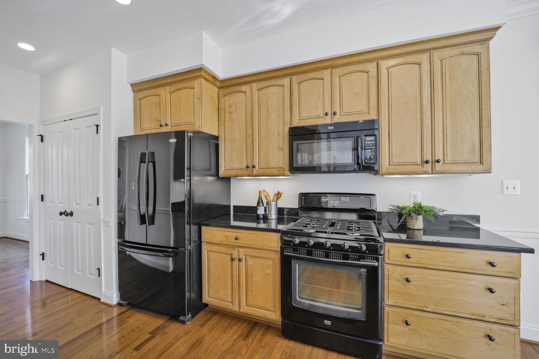 4814 25th Road North Arlington, VA 22207 - Photo 15 of 45 a kitchen with granite countertop a refrigerator stove and microwave