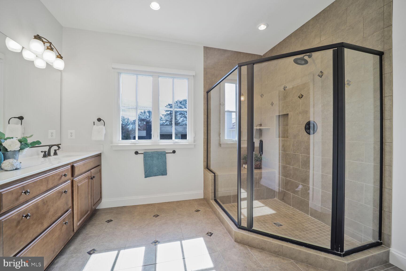 4814 25th Road North Arlington, VA 22207 - Photo 23 of 45 a bathroom with a shower sink and mirror
