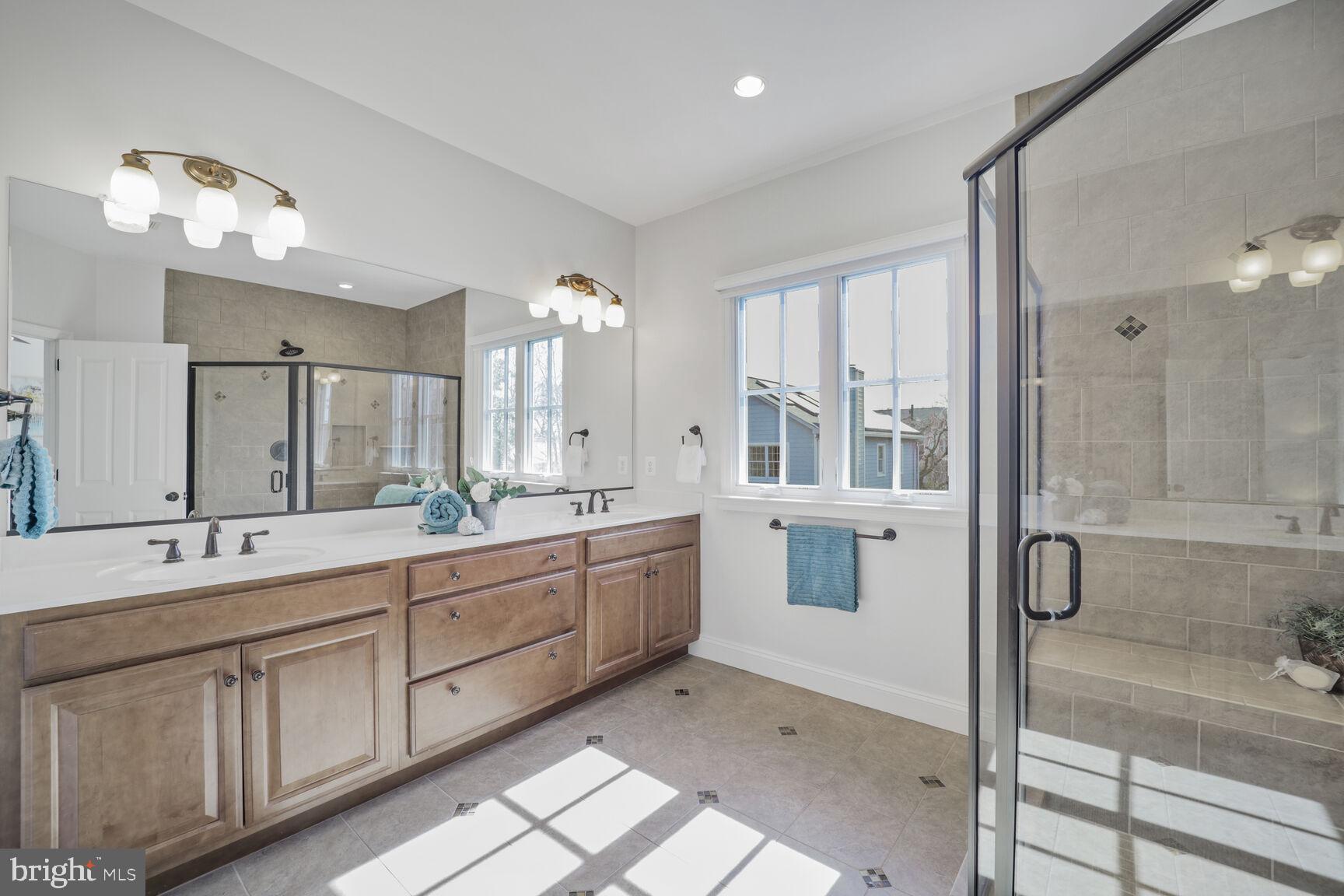 4814 25th Road North Arlington, VA 22207 - Photo 24 of 45 a large bathroom with a double vanity sink a mirror and a shower