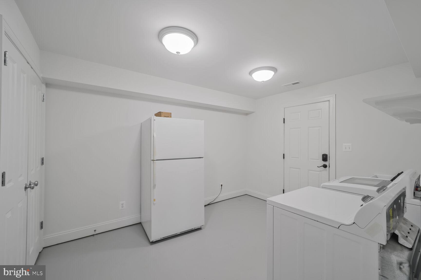 4814 25th Road North Arlington, VA 22207 - Photo 35 of 45 a view of a storage & utility room with dryer and washer