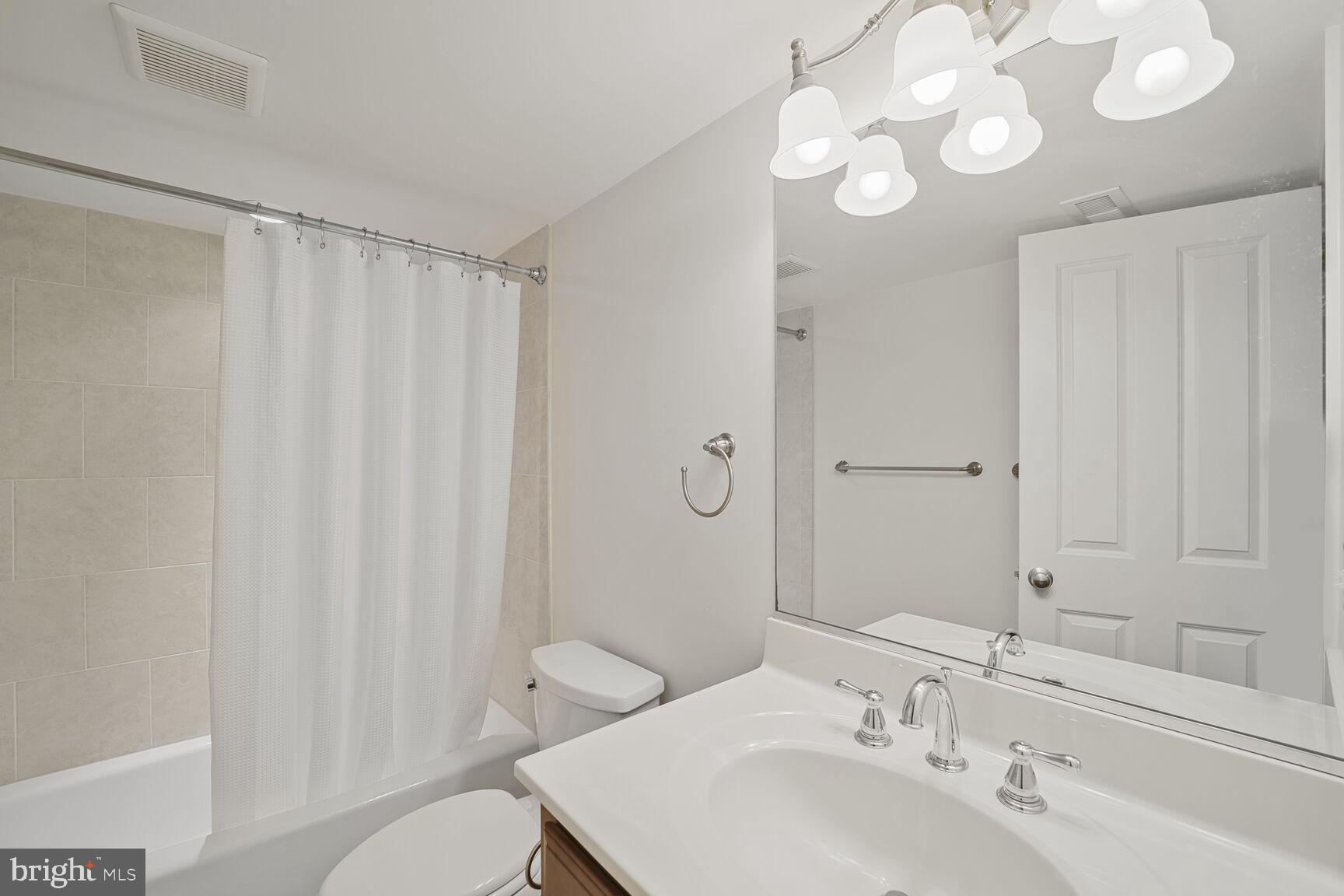 4814 25th Road North Arlington, VA 22207 - Photo 38 of 45 a bathroom with a sink vanity mirror and toilet