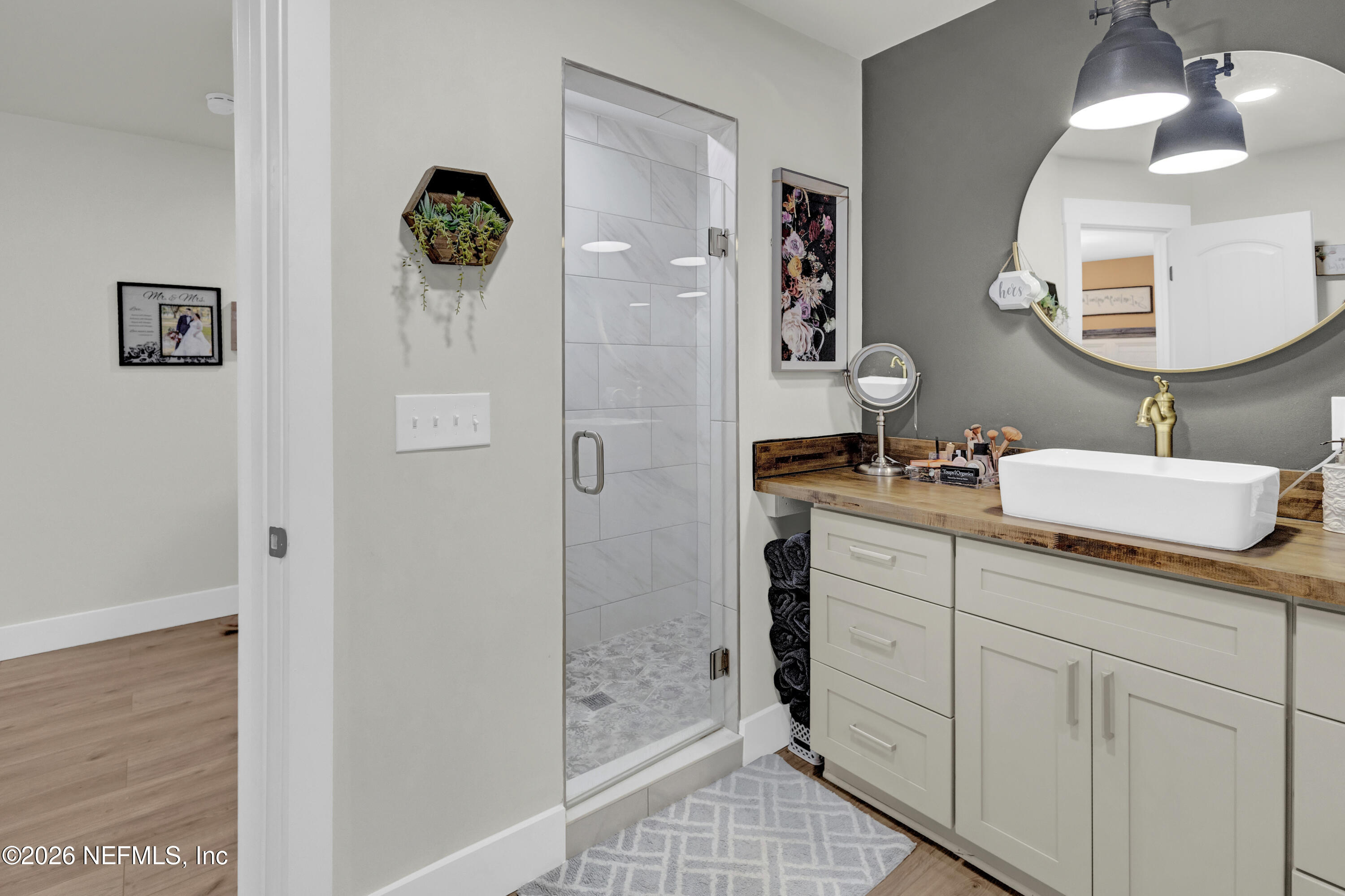 1387 Heath Road Green Cove Springs, FL 32043 - Photo 101 of 136 a bathroom with a sink a mirror and shower
