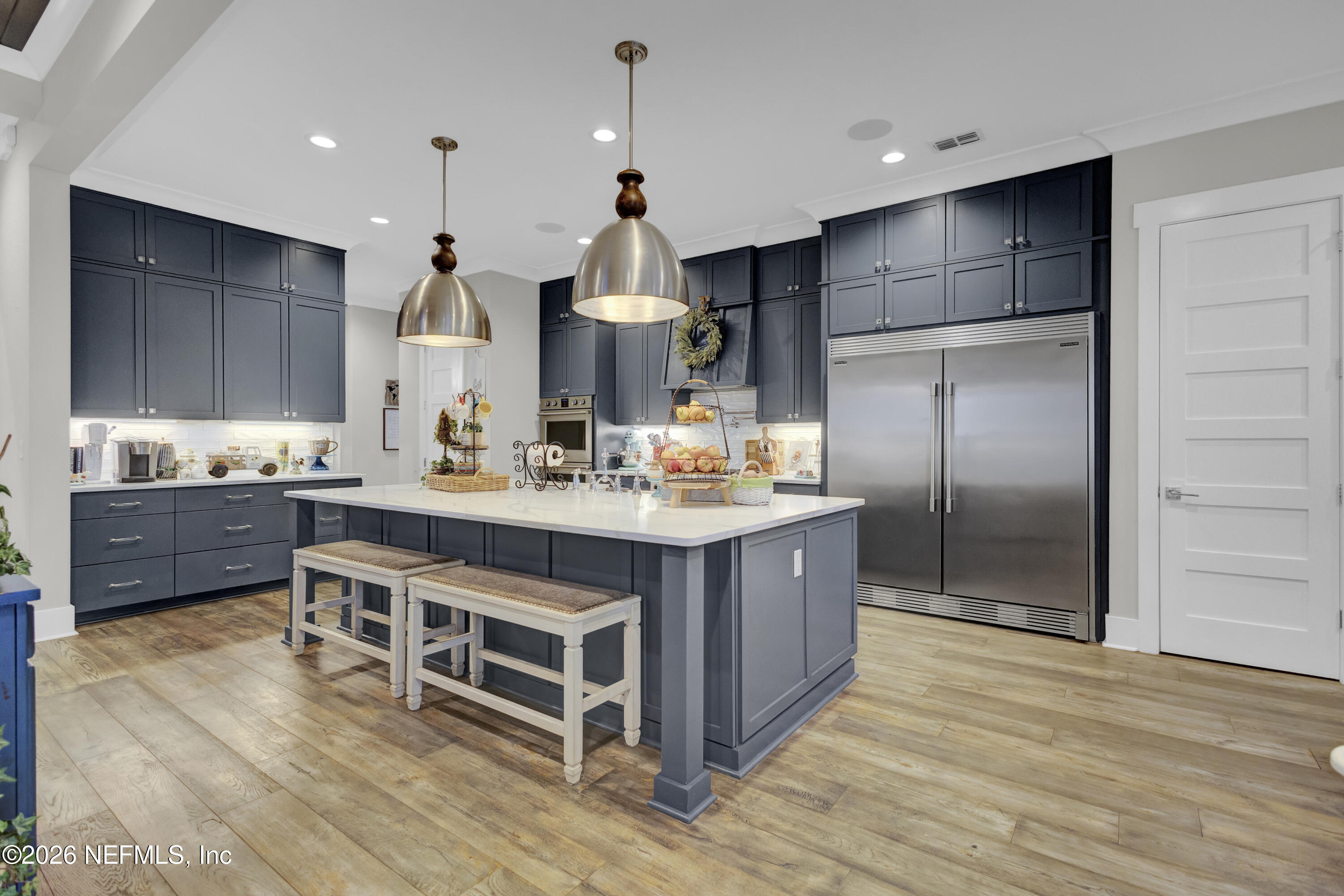 1387 Heath Road Green Cove Springs, FL 32043 - Photo 22 of 136 a kitchen with kitchen island granite countertop a sink cabinets and stainless steel appliances