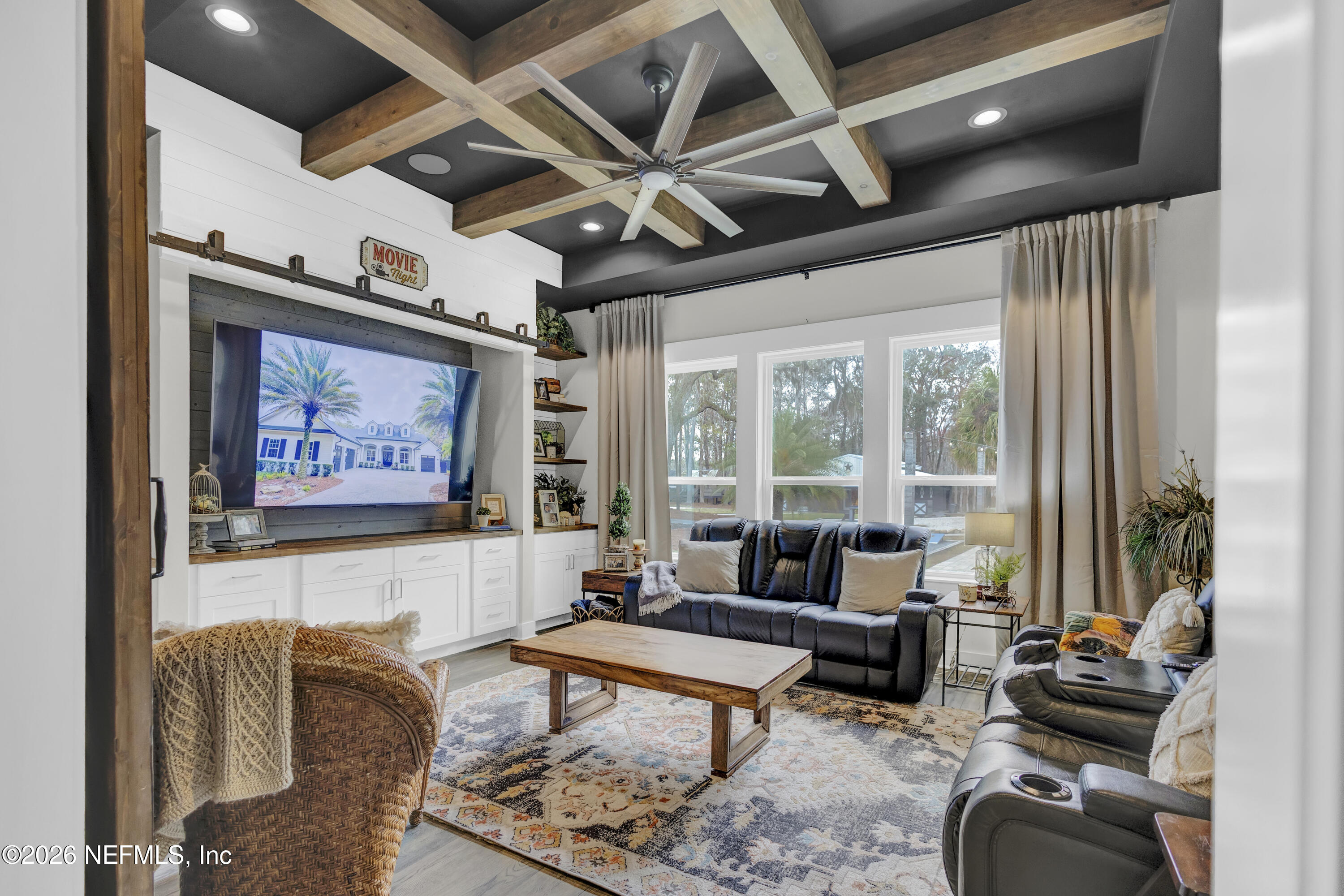 1387 Heath Road Green Cove Springs, FL 32043 - Photo 32 of 136 a living room with furniture a rug and a large window