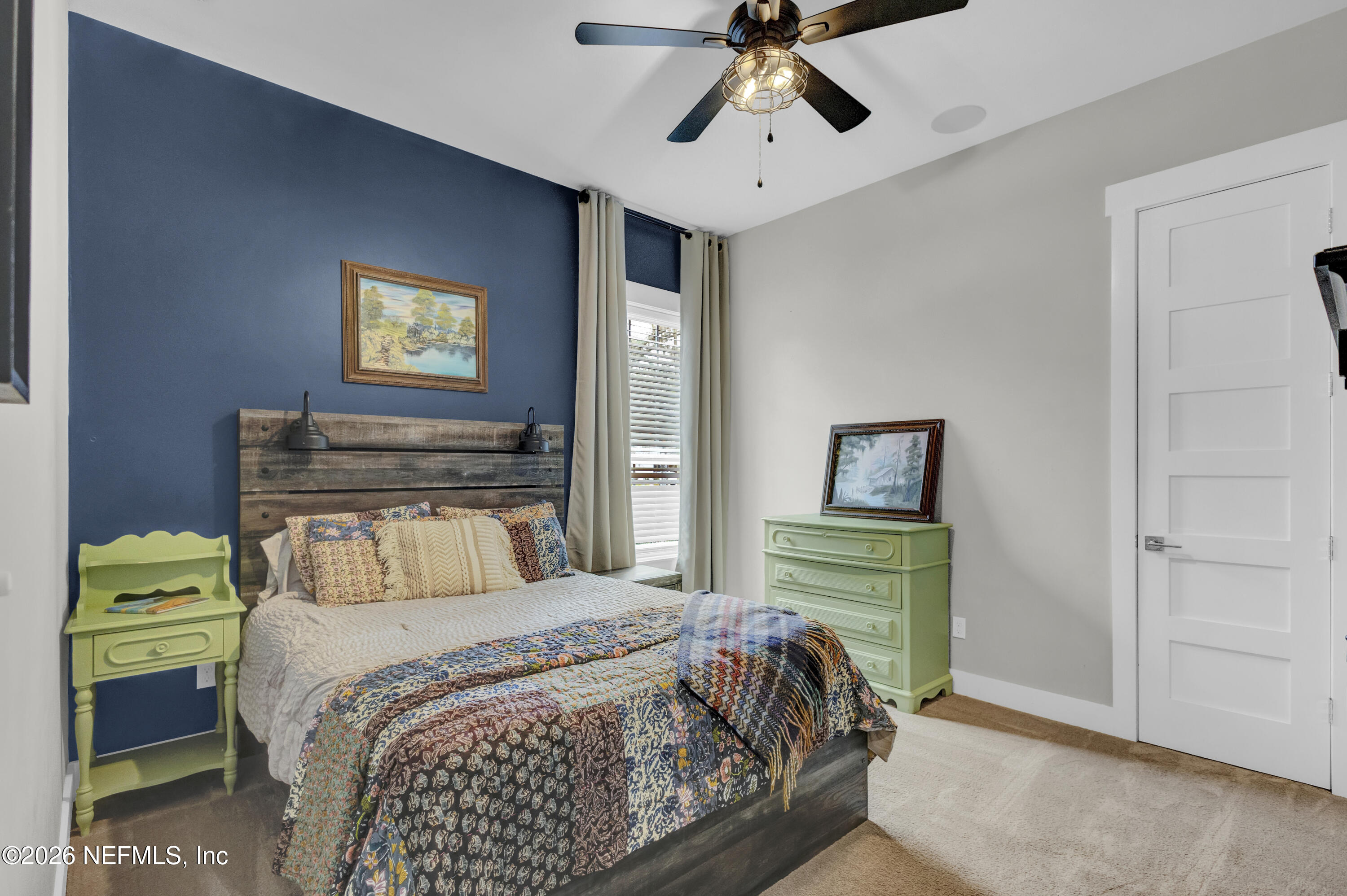 1387 Heath Road Green Cove Springs, FL 32043 - Photo 43 of 136 a bedroom with a bed and a chandelier