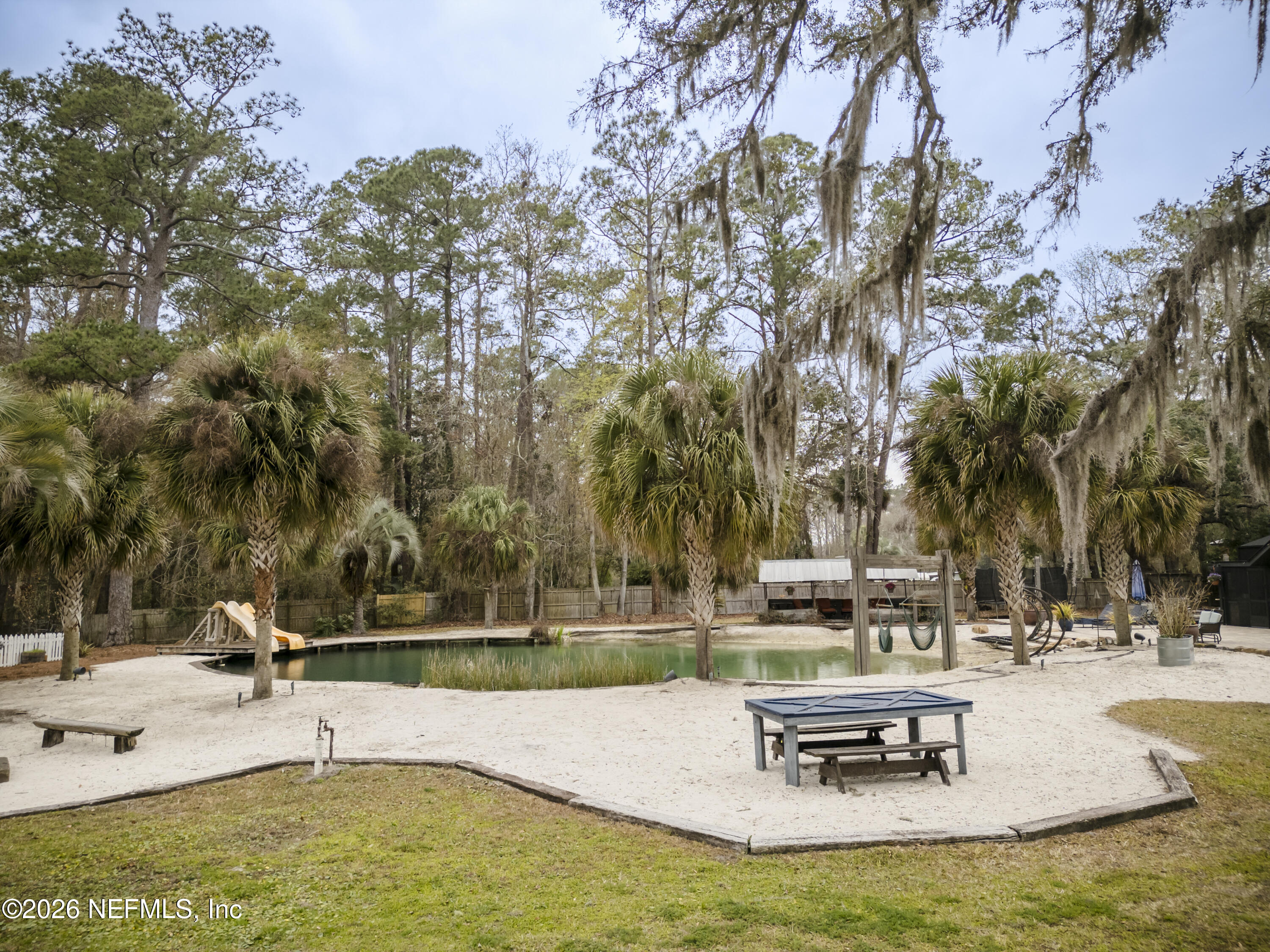1387 Heath Road Green Cove Springs, FL 32043 - Photo 73 of 136 a swimming pool with outdoor seating and trees