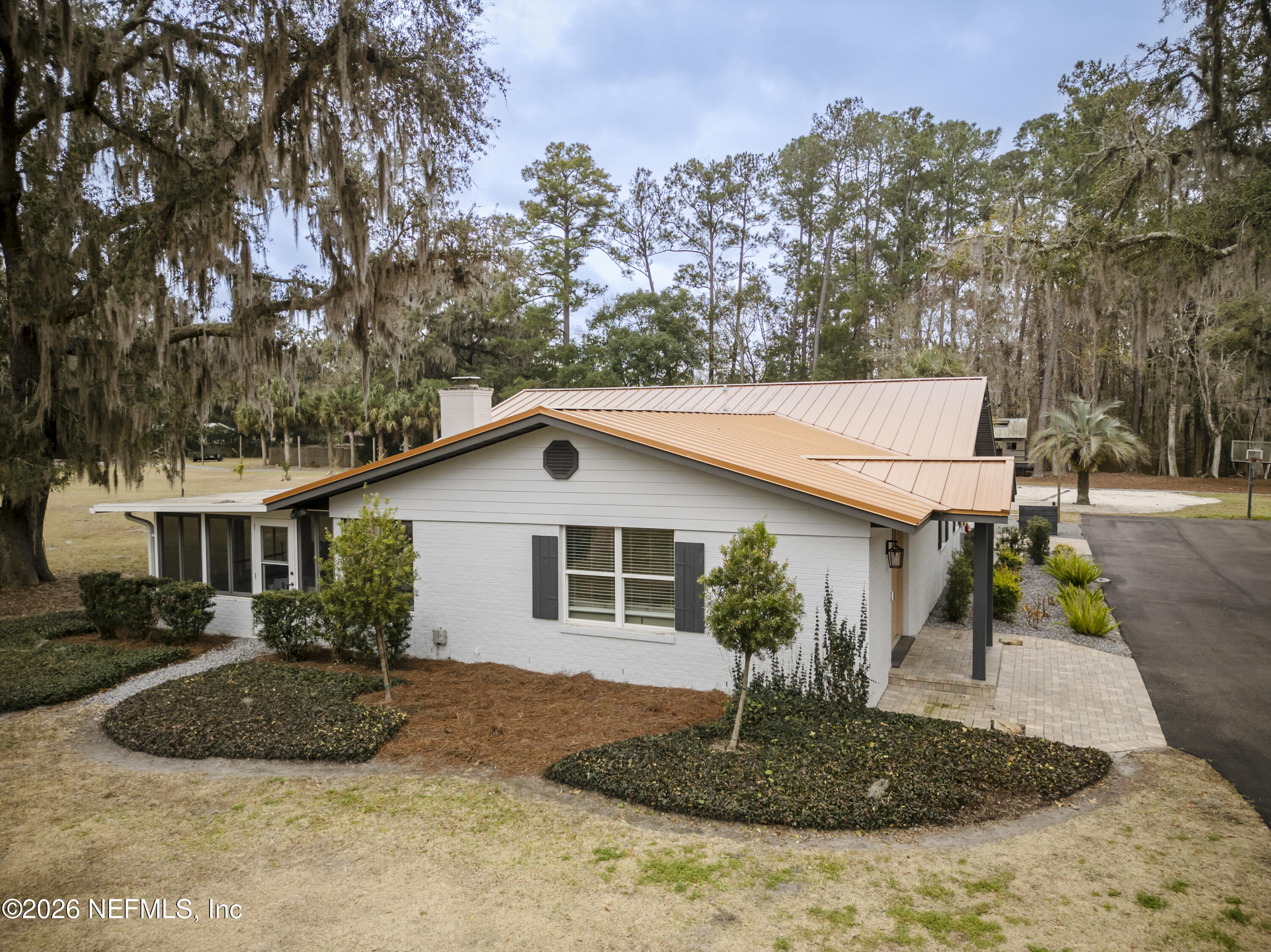 1387 Heath Road Green Cove Springs, FL 32043 - Photo 76 of 136 a view of a house with a yard and potted plants