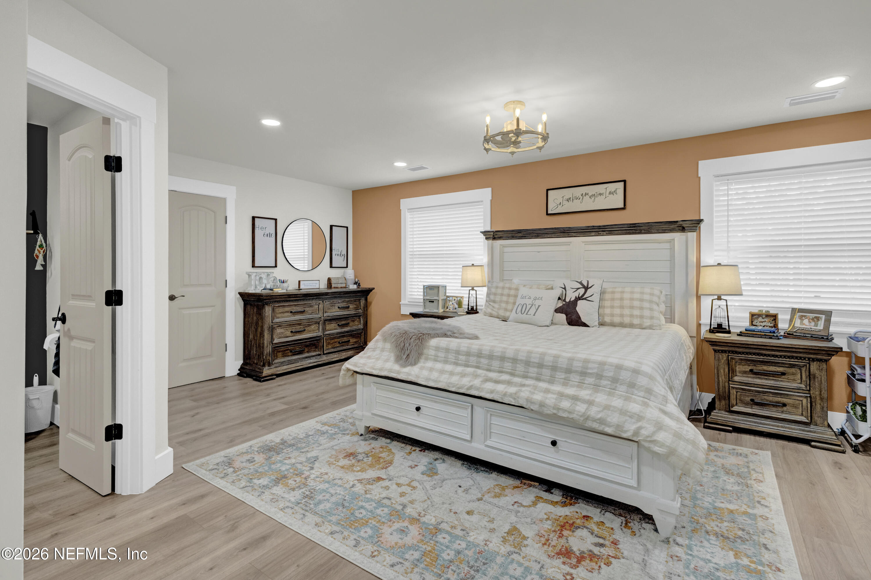 1387 Heath Road Green Cove Springs, FL 32043 - Photo 96 of 136 a bedroom with a bed and a chandelier