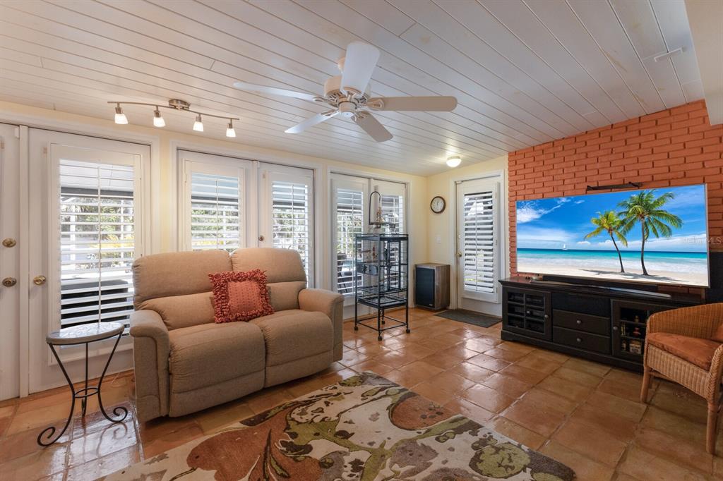 2723 59th Street Sarasota, FL 34243 - Photo 20 of 75 a living room with furniture and a flat screen tv