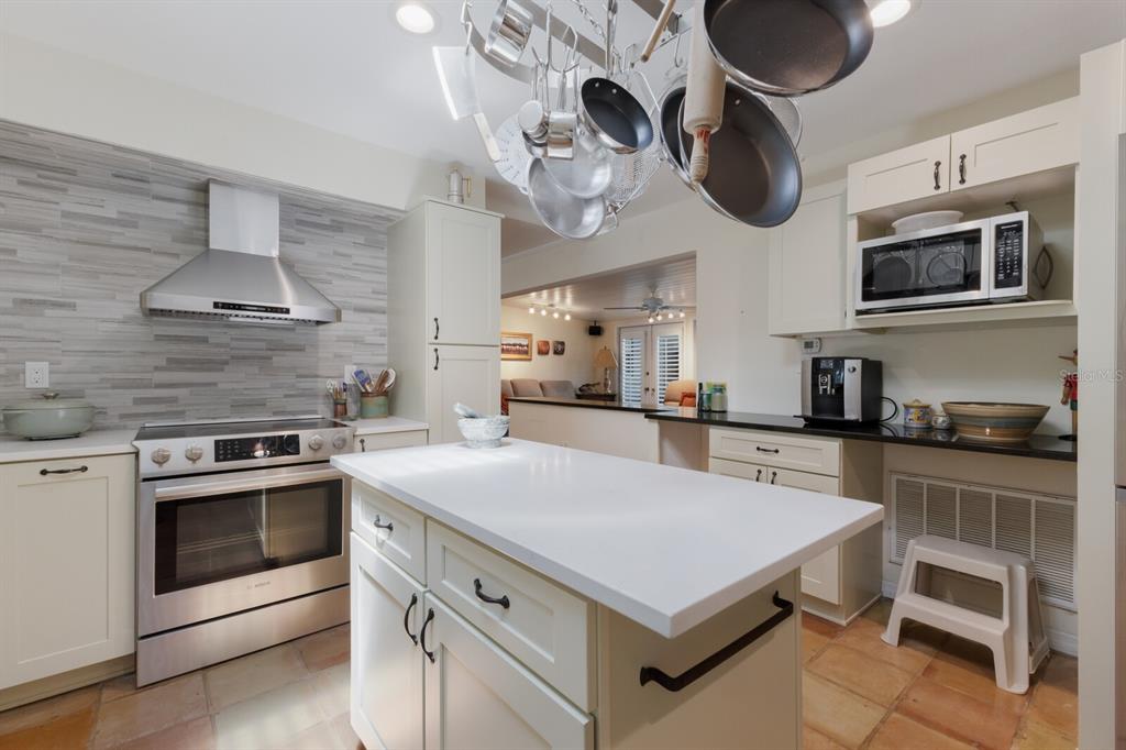 2723 59th Street Sarasota, FL 34243 - Photo 25 of 75 a kitchen with a stove cabinets and stainless steel appliances