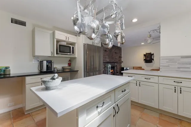 a utility room with dryer washer and a view of living area