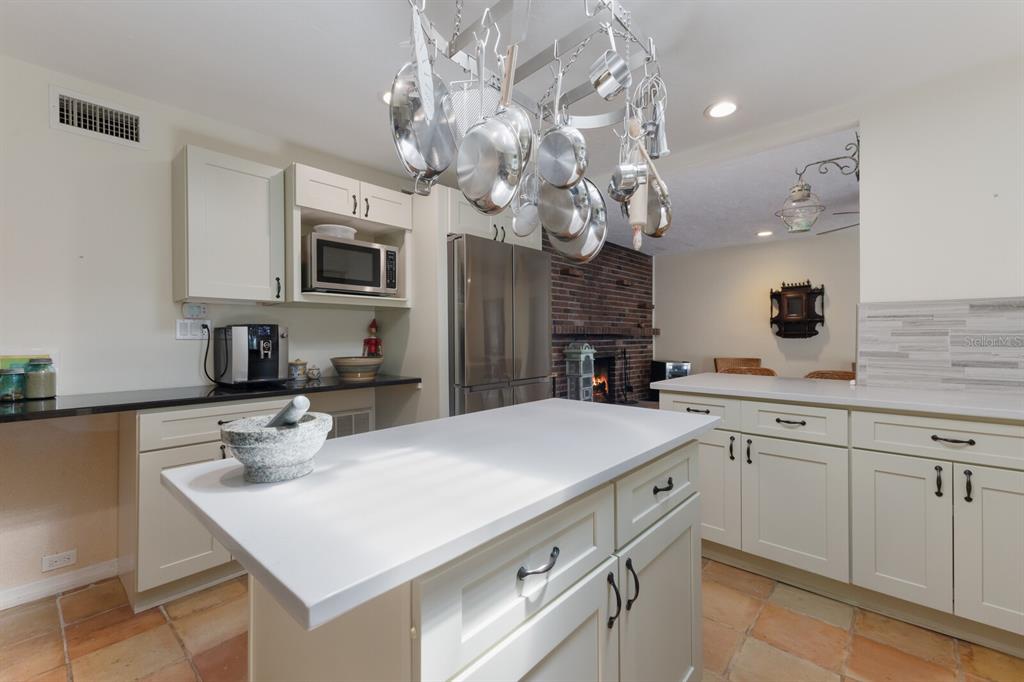 2723 59th Street Sarasota, FL 34243 - Photo 27 of 75 a kitchen with a sink a microwave and cabinets