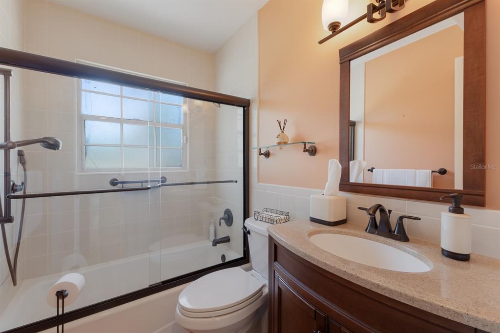 2723 59th Street Sarasota, FL 34243 - Photo 40 of 75 a bathroom with a granite countertop sink toilet and shower