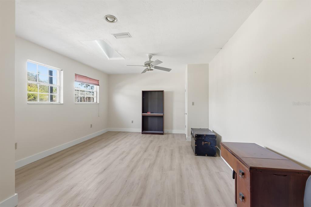 2723 59th Street Sarasota, FL 34243 - Photo 43 of 75 wooden floor in an empty room with a window