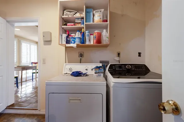 an aerial view of a residential houses with outdoor space and a lake view