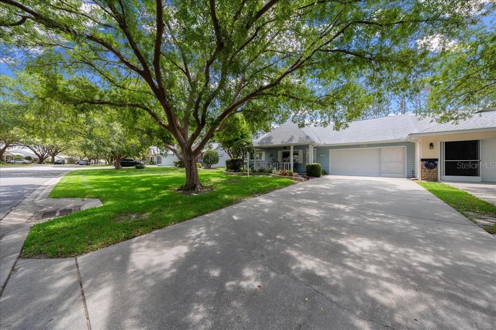 8720 Southwest 90th Street, Unit A Ocala, FL 34481 - Photo 6 of 71 a front view of a house with a garden and trees