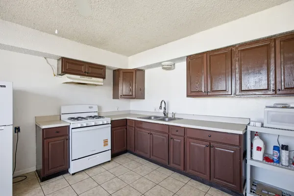 a kitchen with a sink stove and cabinets