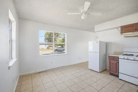 a view of kitchen with windows and ceiling fan