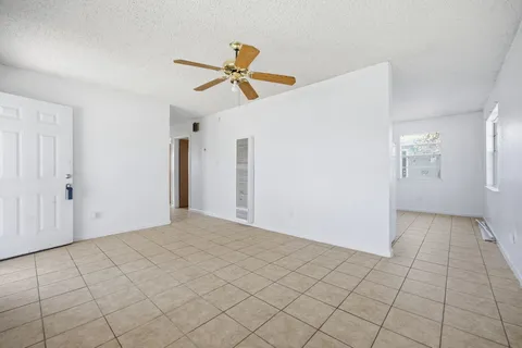 a view of a livingroom with wooden floor and cabinet