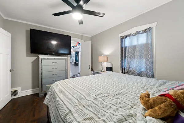 a bedroom with a large bed and a flat screen tv