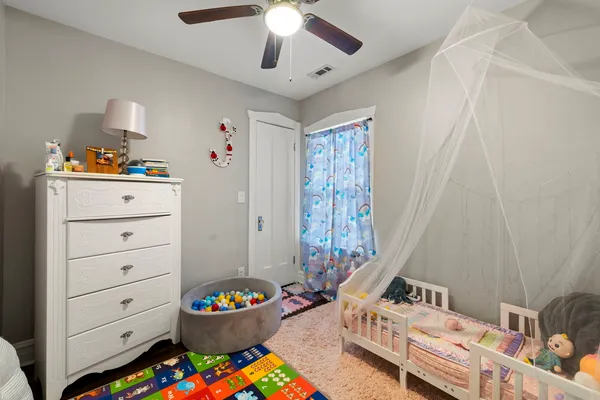 a bedroom with a bed and a window