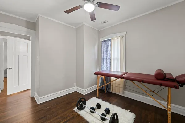 a view of a workspace with furniture and wooden floor