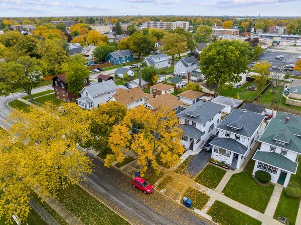 an aerial view of residential houses with yard