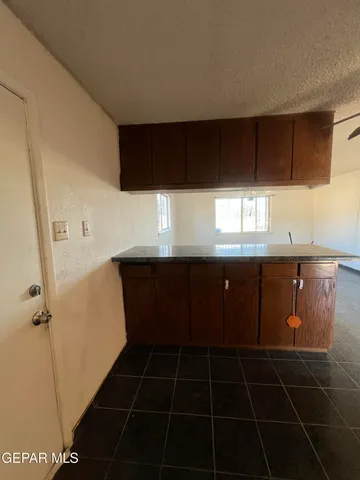 a kitchen with a sink a cabinetry and a window