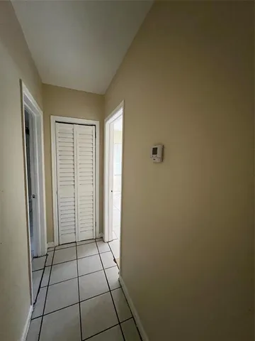 a view of an empty room and a bathroom