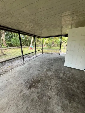 a view of an empty room and a window