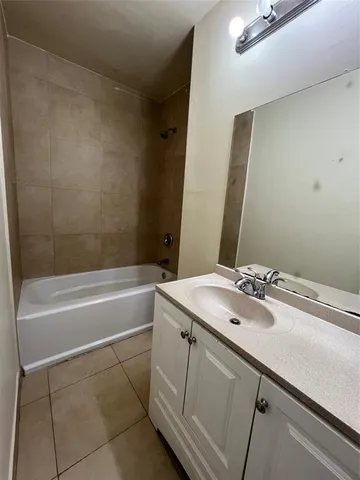 a view of an empty room and a bathroom