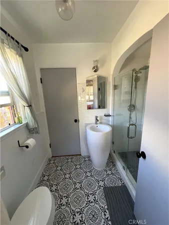 a spacious bathroom with a toilet sink and mirror