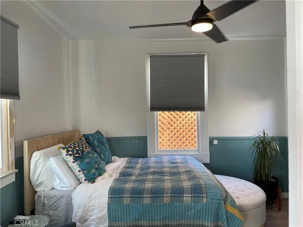 a bedroom with a bed couch and window