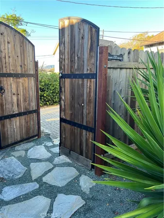 a view of a backyard with wooden fence
