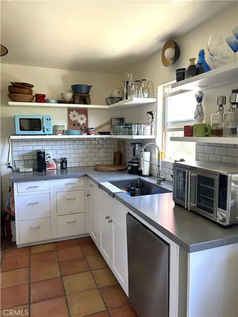 a kitchen with stainless steel appliances granite countertop a sink and cabinets