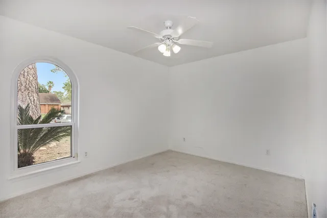 an empty room with window and outdoor view