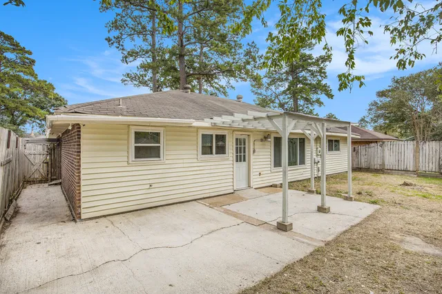 a white house that has a tree in front of it