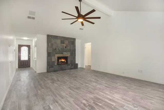 wooden floor in an empty room with a fireplace