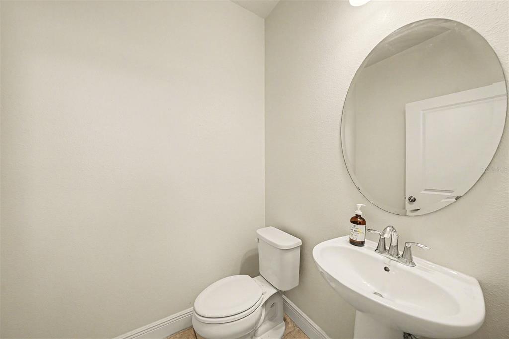 10210 Newel Valley Loop Riverview, FL 33569 - Photo 11 of 30 a white toilet sitting next to a bathroom sink