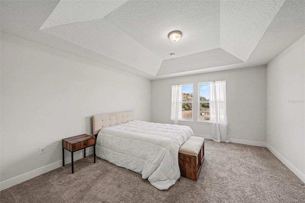 10210 Newel Valley Loop Riverview, FL 33569 - Photo 14 of 30 a spacious bedroom with a bed and a window