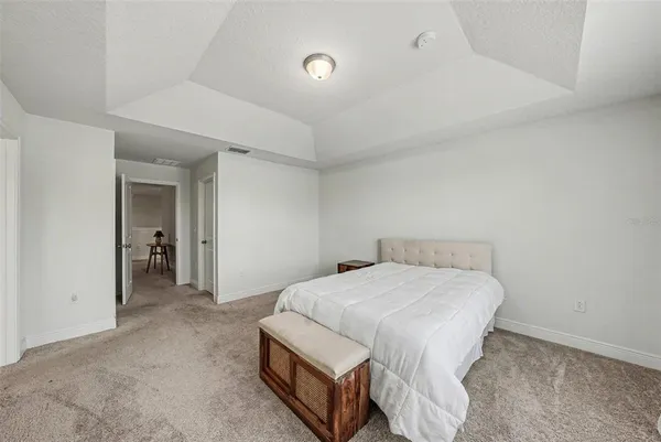 a bedroom with a bed and a lamp