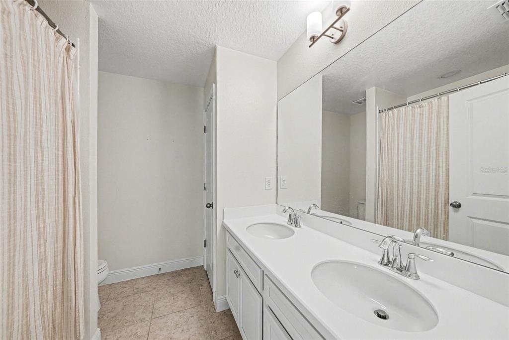 10210 Newel Valley Loop Riverview, FL 33569 - Photo 19 of 30 a bathroom with a double vanity sink and a mirror