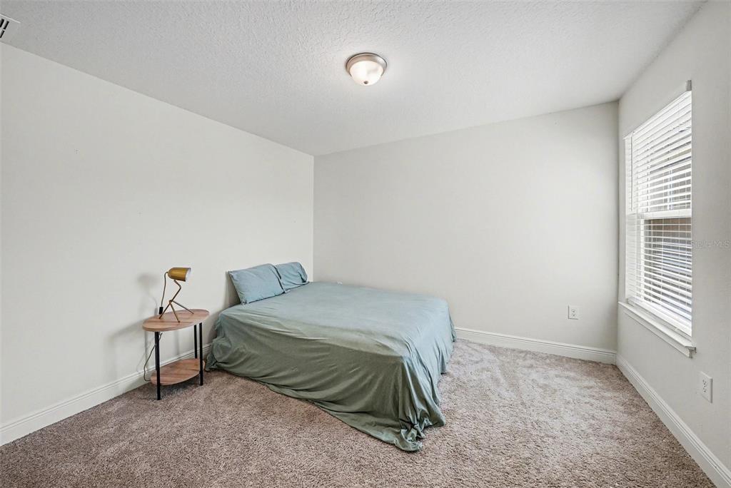 10210 Newel Valley Loop Riverview, FL 33569 - Photo 20 of 30 a bedroom with a bed and window