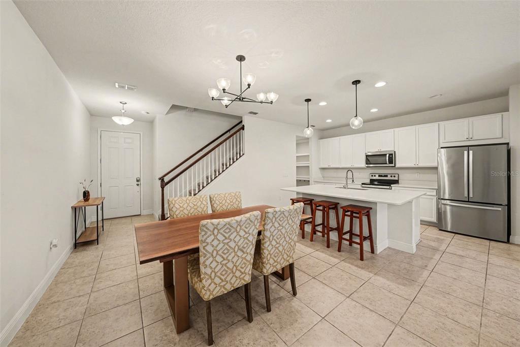 10210 Newel Valley Loop Riverview, FL 33569 - Photo 3 of 30 a kitchen with a dining table chairs and refrigerator
