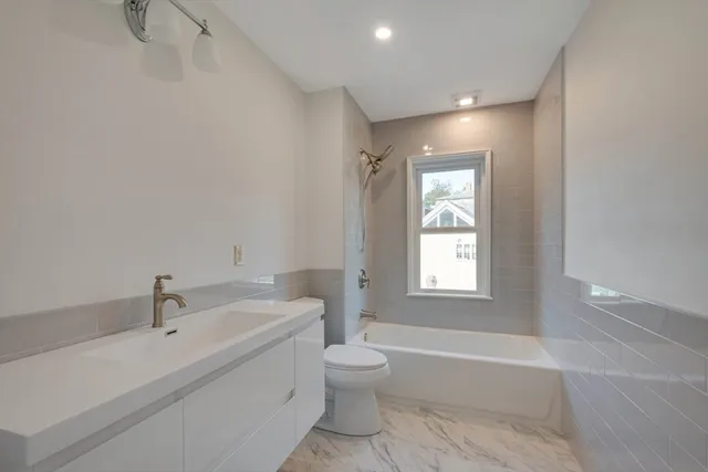 an empty room with a window and wooden floor