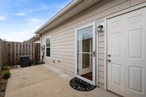 a view of a porch with wooden floor and fence