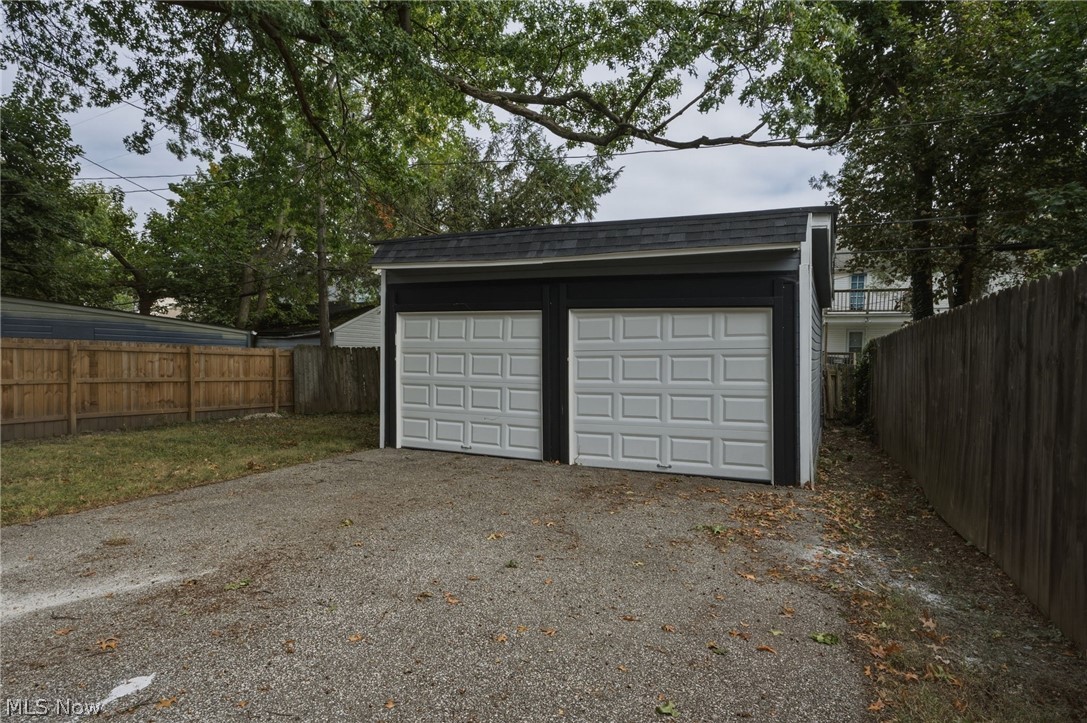 1173 Yellowstone Road Cleveland Heights, OH 44121 - Photo 35 of 44 Detached two-car garage with white paneled doors, dark siding, and a sloped roof