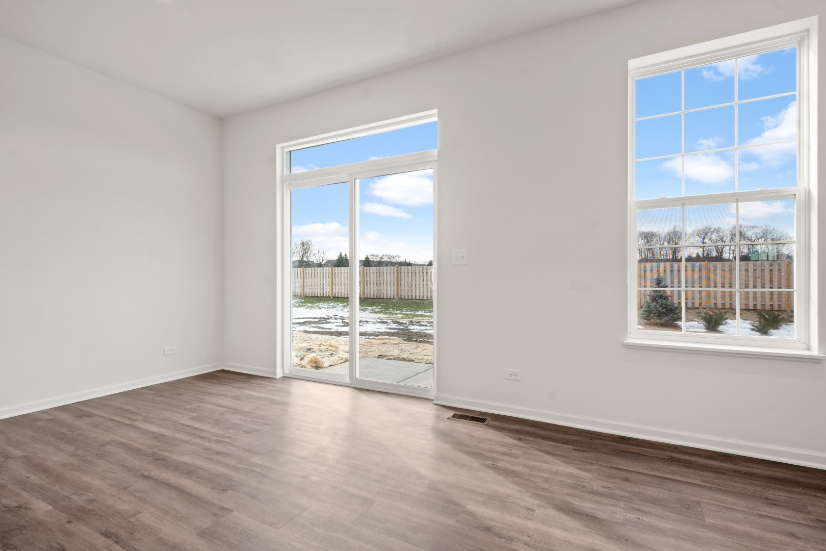 2057 Stuttle Road Batavia, IL 60510 - Photo 6 of 20 an empty room with wooden floor and windows