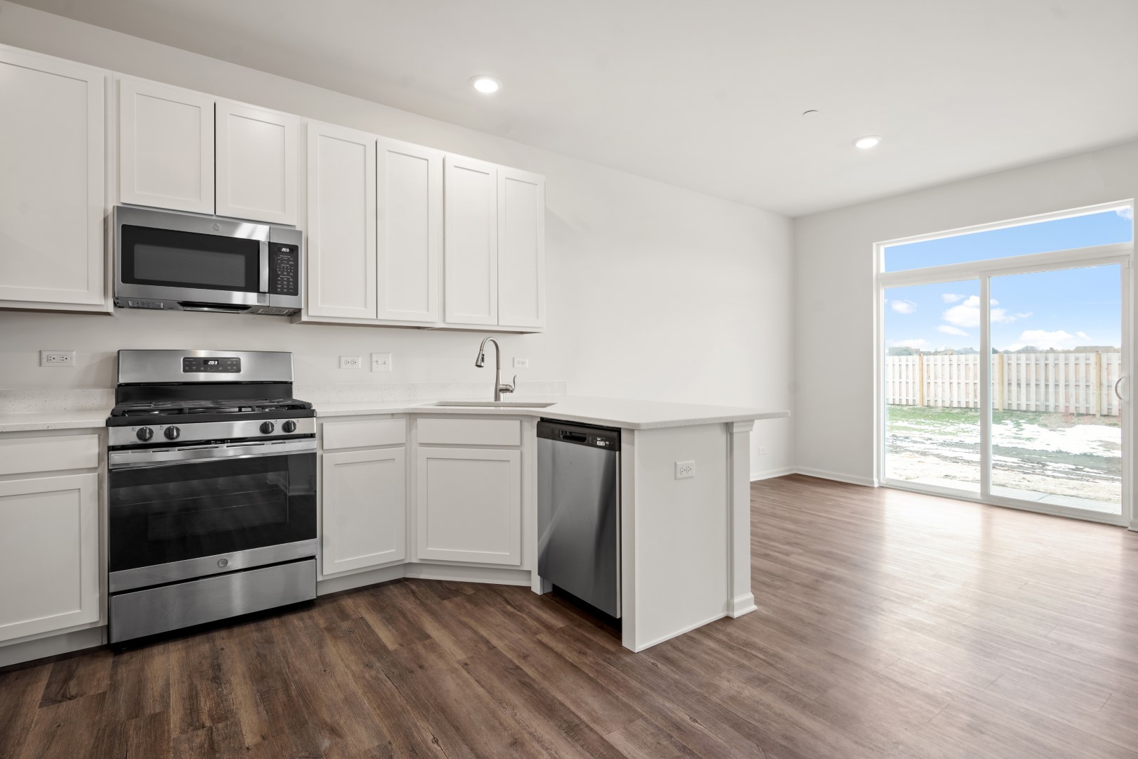 2057 Stuttle Road Batavia, IL 60510 - Photo 10 of 20 a kitchen with stainless steel appliances granite countertop a stove a sink and a microwave