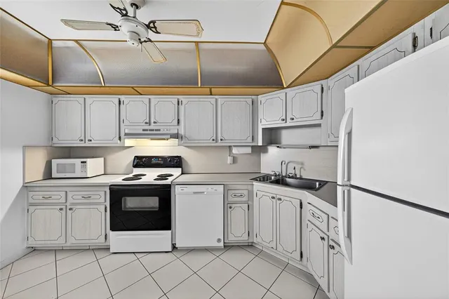 a kitchen with granite countertop cabinets stainless steel appliances and a sink